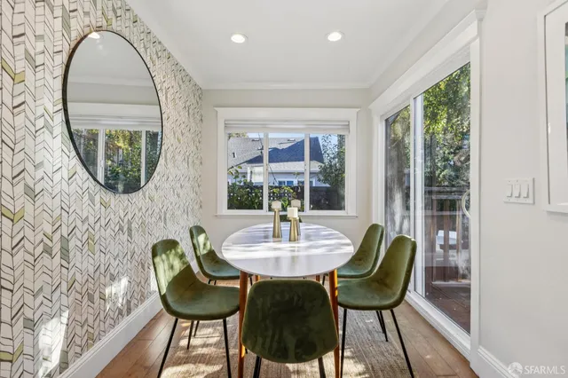 a dining room with furniture and a mirror