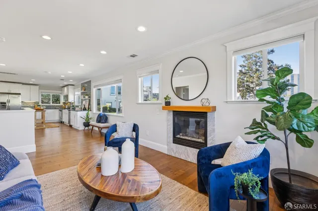 a living room with fireplace furniture and a large window