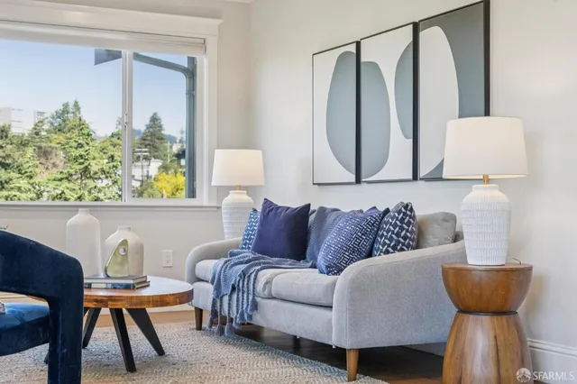 a living room with a couch and a potted plant