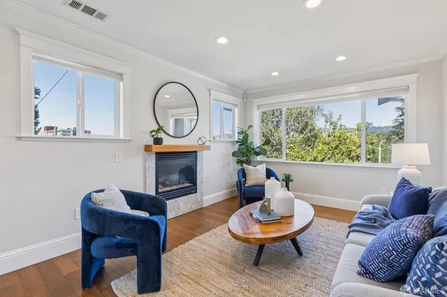 a living room with furniture a window and a fireplace
