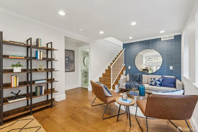 a living room with furniture and a mirror