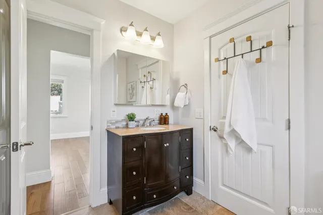 a bathroom with a sink vanity and mirror