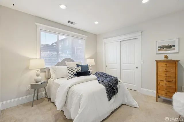 a bedroom with a bed and a dresser