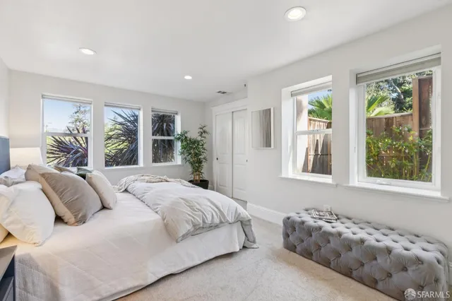 a bedroom with bed and a large window