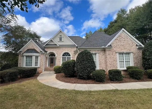 a front view of a house with a yard