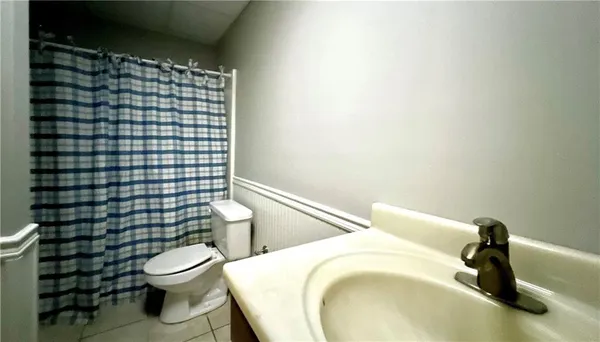 a white toilet sitting next to a bathroom sink
