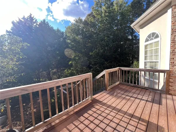 a view of balcony with wooden floor and fence