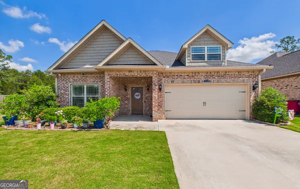 a front view of a house with a yard and garage