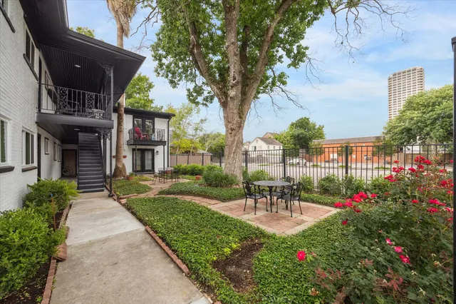 a view of a patio with table and chairs and potted plants