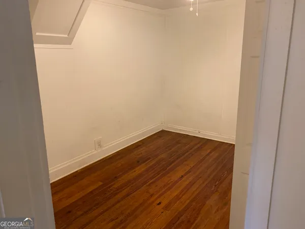 an empty room with closet area