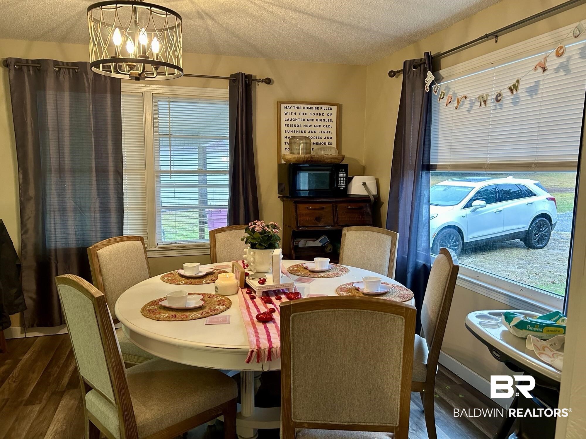 3850 Newman Road Mobile, AL 36695 - Photo 5 of 27 Dining room featuring dark hardwood / wood-style floors, a textured ceiling, and a chandelier