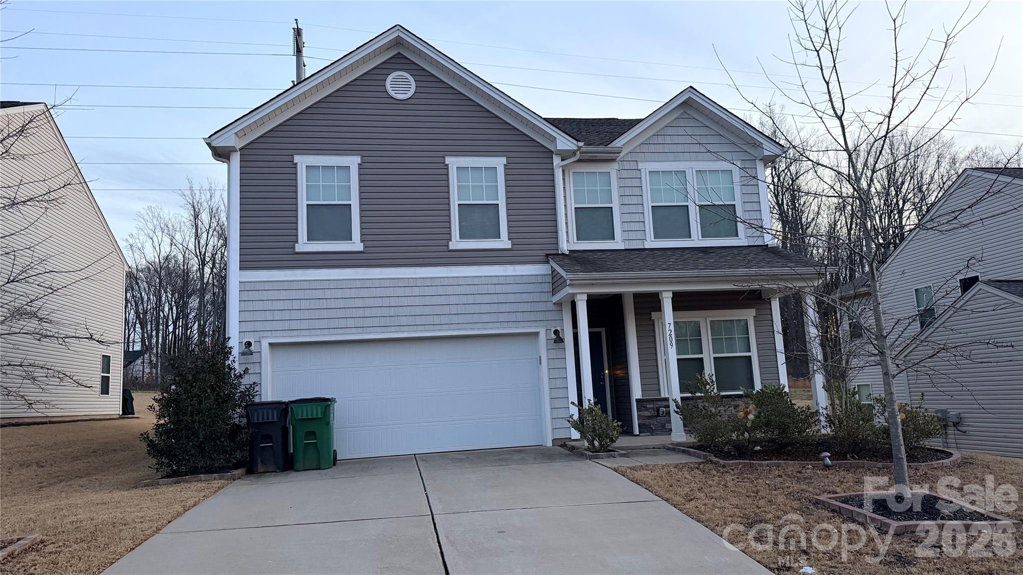 7209 Lenton Road, Unit 23 Charlotte, NC 28215 - Photo 1 of 17 a front view of a house with garden