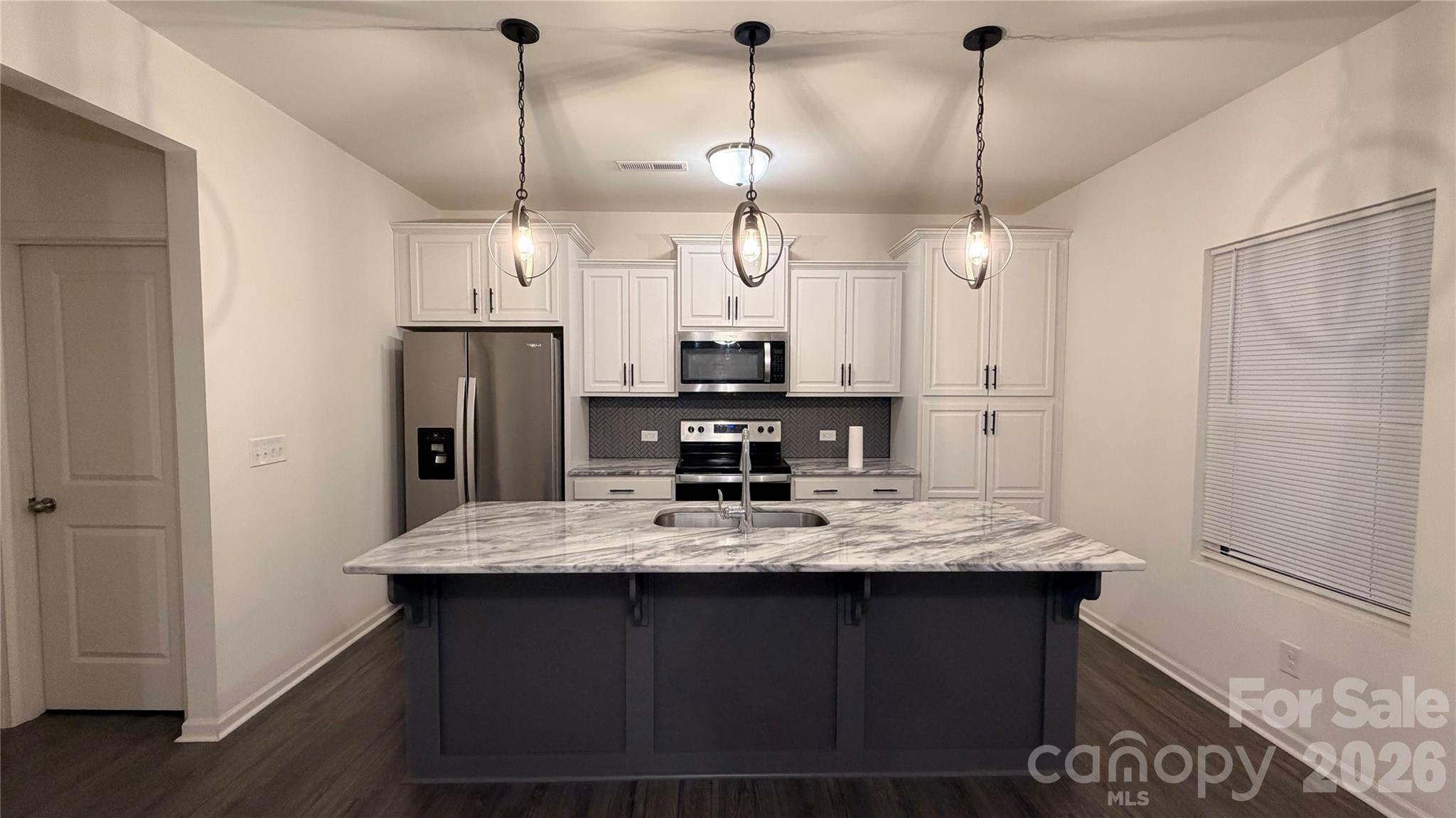 7209 Lenton Road, Unit 23 Charlotte, NC 28215 - Photo 6 of 17 a kitchen with refrigerator and countertop