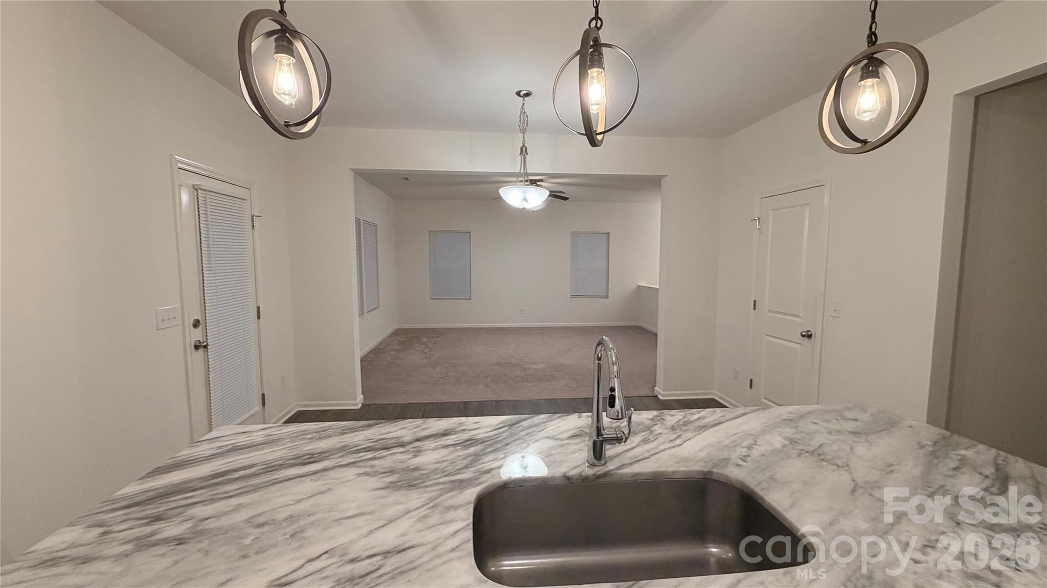 7209 Lenton Road, Unit 23 Charlotte, NC 28215 - Photo 7 of 17 a view of a livingroom and a chandelier fan