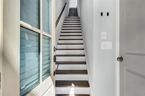 a view of entryway and hall with wooden floor