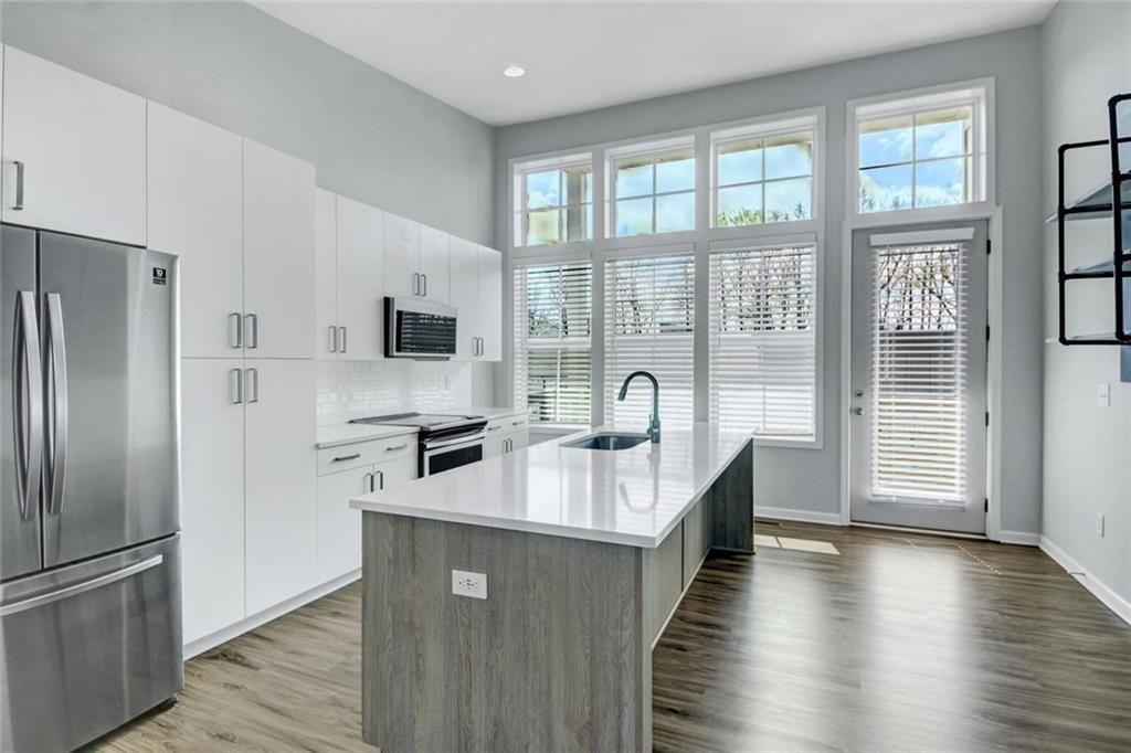 900 Brees Court Atlanta, GA 30318 - Photo 3 of 33 a kitchen with stainless steel appliances granite countertop a refrigerator a sink and a stove