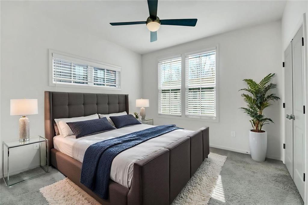 900 Brees Court Atlanta, GA 30318 - Photo 5 of 33 a bedroom with a large bed and a potted plant