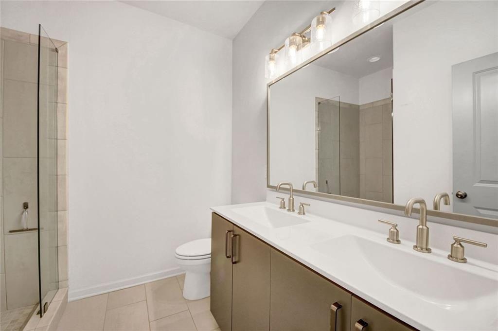 900 Brees Court Atlanta, GA 30318 - Photo 6 of 33 a bathroom with a double vanity sink toilet and a mirror