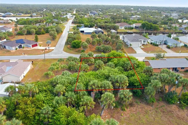 an aerial view of residential houses with outdoor space and trees