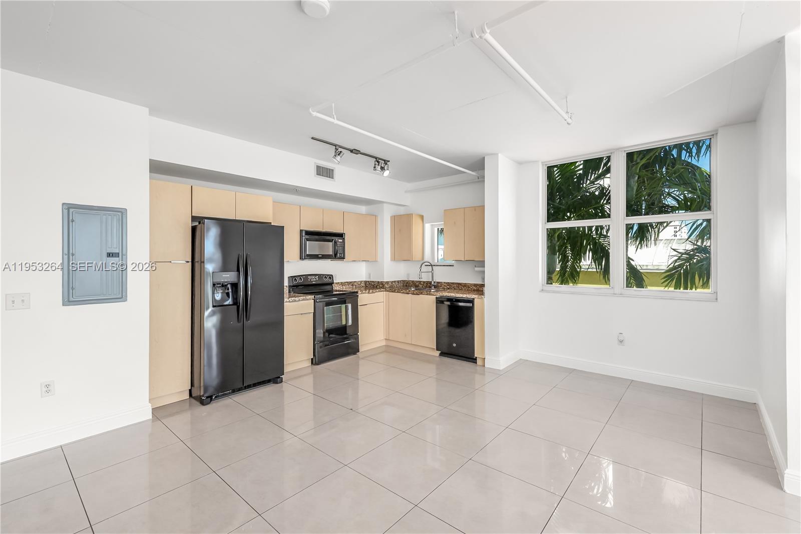 3180 Southwest 22nd Street, Unit 601 Miami, FL 33145 - Photo 12 of 29 a kitchen with stainless steel appliances granite countertop a refrigerator and a stove top oven