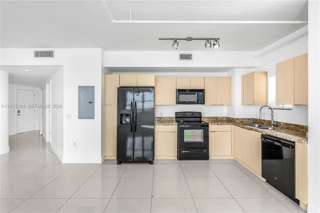 a kitchen with stainless steel appliances granite countertop a stove and a refrigerator