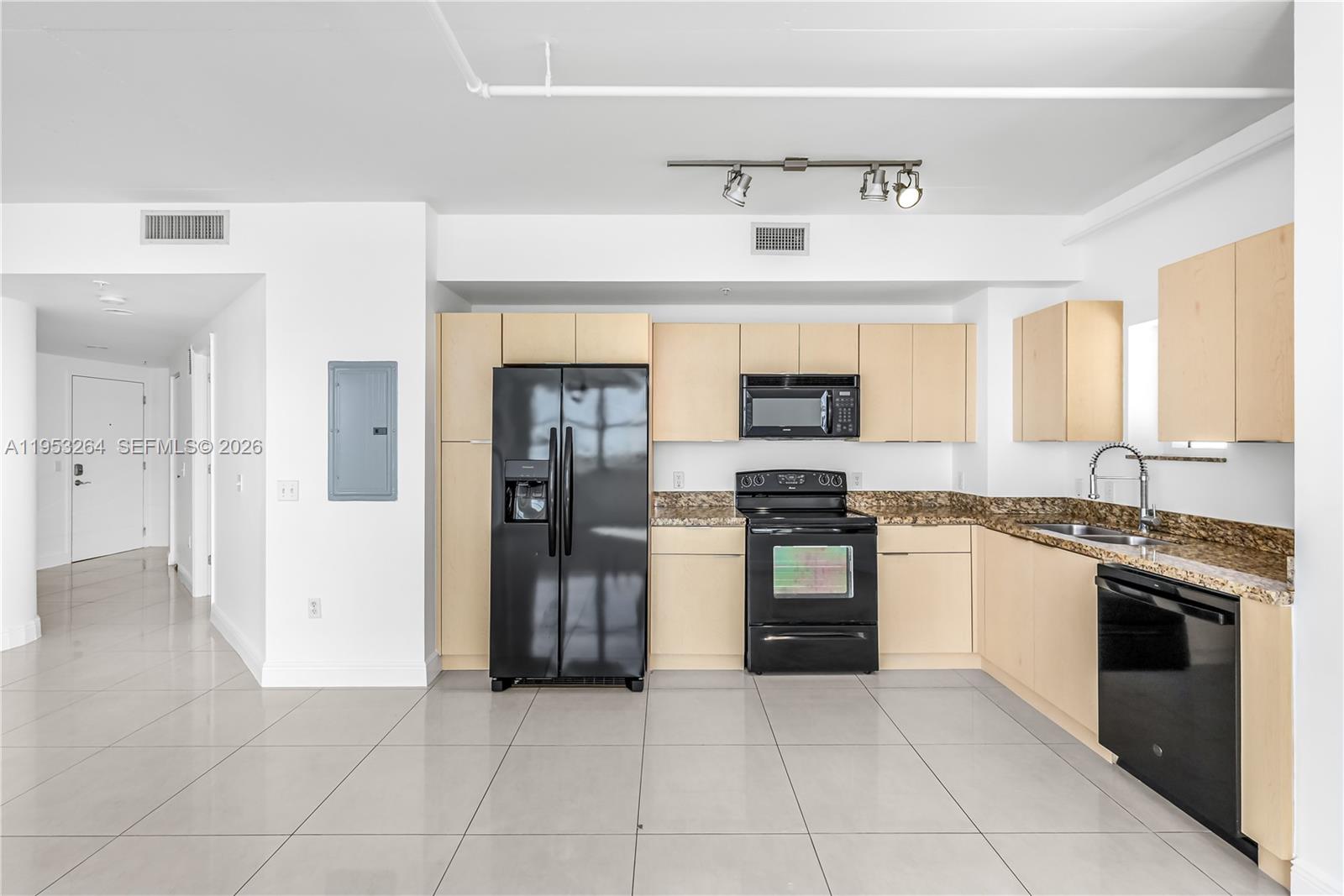 3180 Southwest 22nd Street, Unit 601 Miami, FL 33145 - Photo 13 of 29 a kitchen with stainless steel appliances granite countertop a stove and a refrigerator
