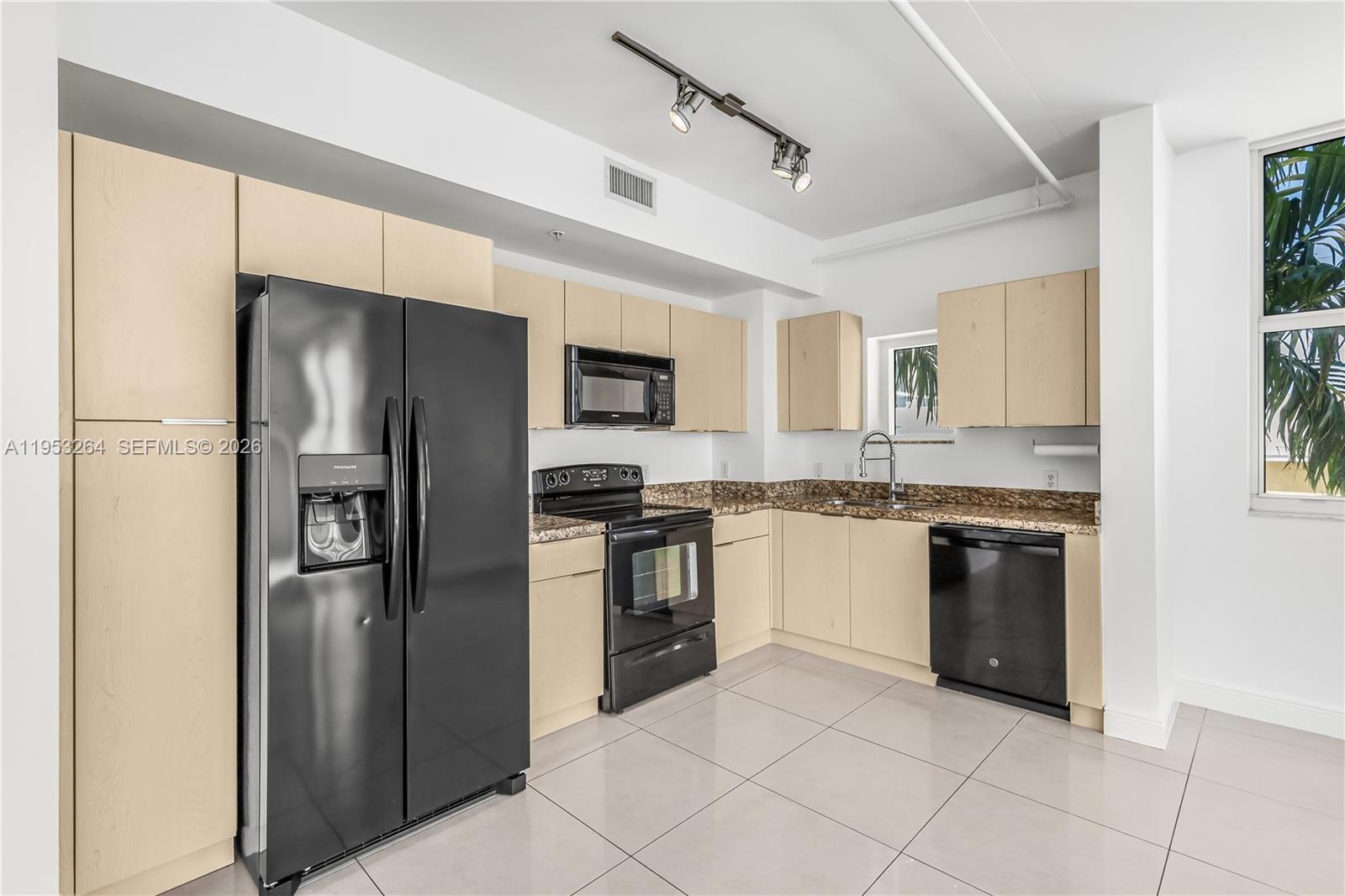 3180 Southwest 22nd Street, Unit 601 Miami, FL 33145 - Photo 16 of 29 a kitchen with stainless steel appliances granite countertop a refrigerator and a stove top oven