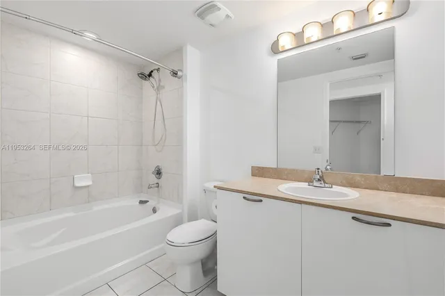 a bathroom with a granite countertop sink a toilet and shower