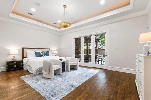 a bedroom with a large bed and a wooden floor