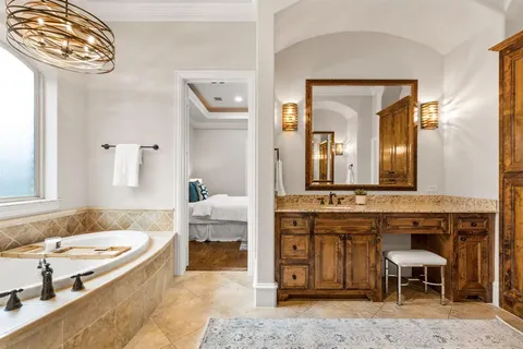 a spacious bathroom with a granite countertop sink and a mirror