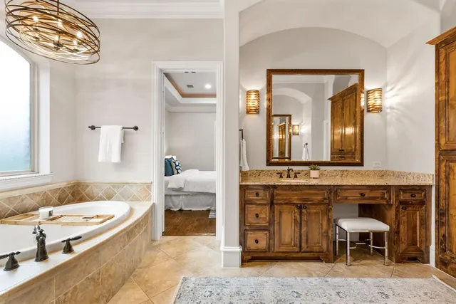 a spacious bathroom with a granite countertop sink and a mirror