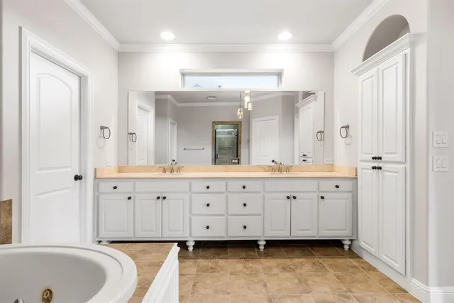 a bathroom with double vanity and a mirror