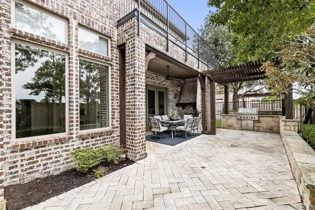 a building outdoor space with patio furniture and potted plants