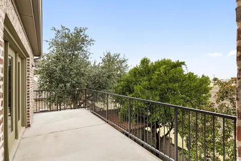 a view of a balcony with trees