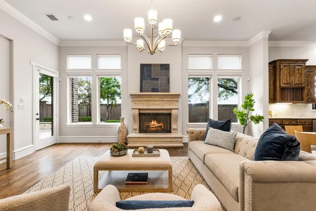 a living room with furniture a large window and a fireplace