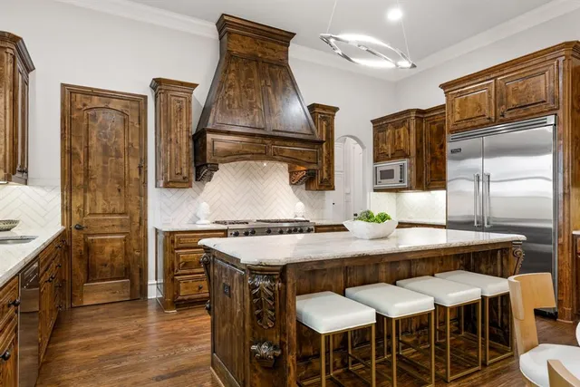 a kitchen with a table chairs stove and cabinets