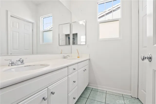 a bathroom with a double vanity sink and a mirror