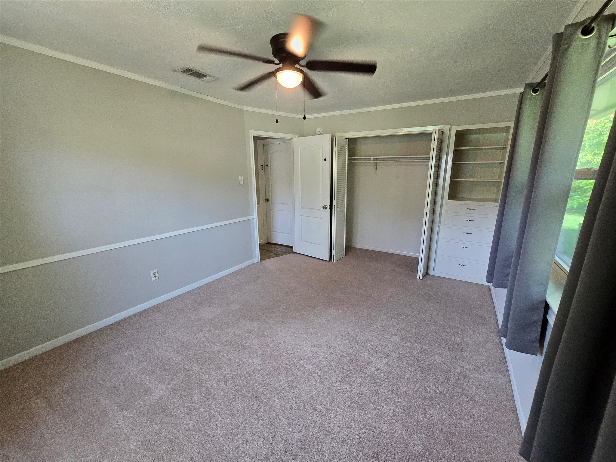 205 East Cherokee Drive Harker Heights, TX 76548 - Photo 18 of 23 Well-appointed bedroom featuring a ceiling fan and ample built-in storage for organized living.