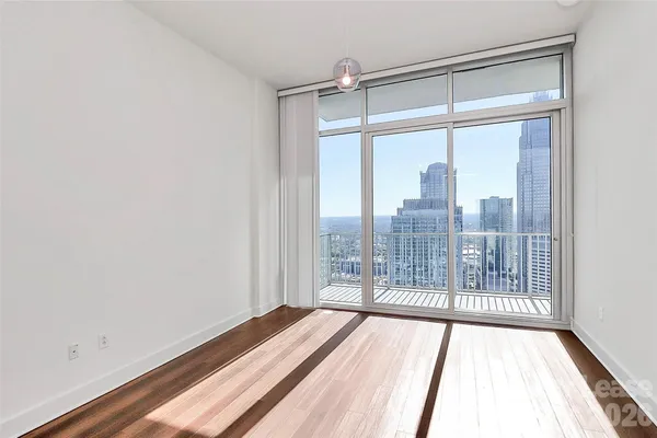 a view of a room with wooden floor and windows