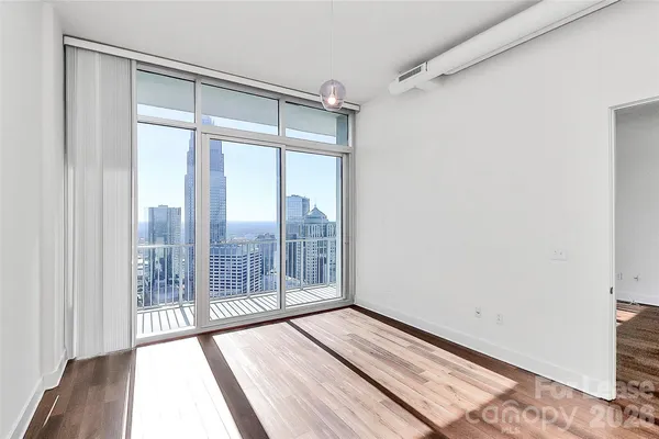 a view of an empty room and wooden floor