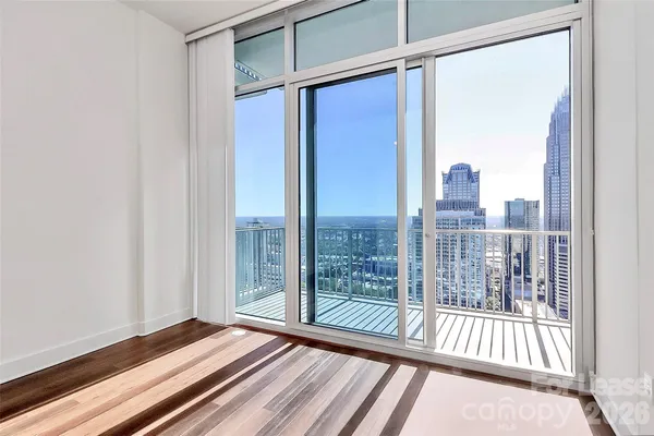 a view of a room with wooden floor and windows