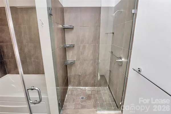 a bathroom with a shower and a sink