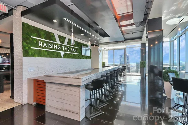 a living room with patio furniture and a flat screen tv