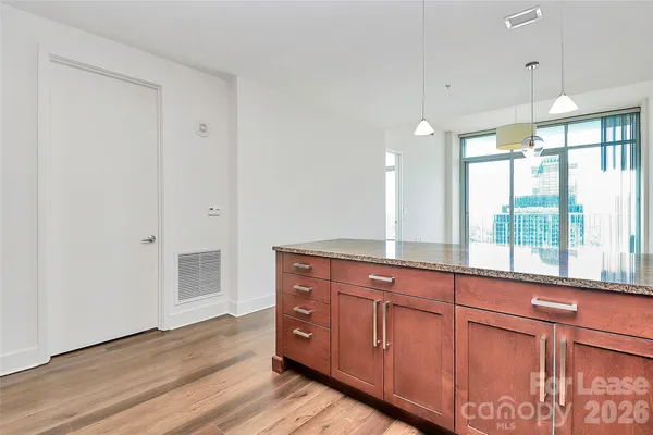 a spacious bathroom with a granite countertop sink and a large mirror