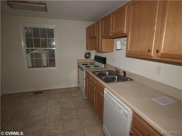 147 Rosegill Road Richmond, VA 23236 - Photo 2 of 6 a kitchen with granite countertop a sink a stove and cabinets