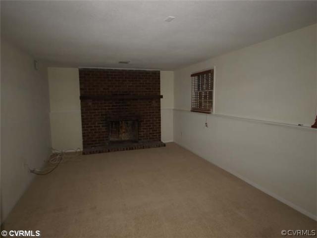147 Rosegill Road Richmond, VA 23236 - Photo 3 of 6 an empty room with a fireplace