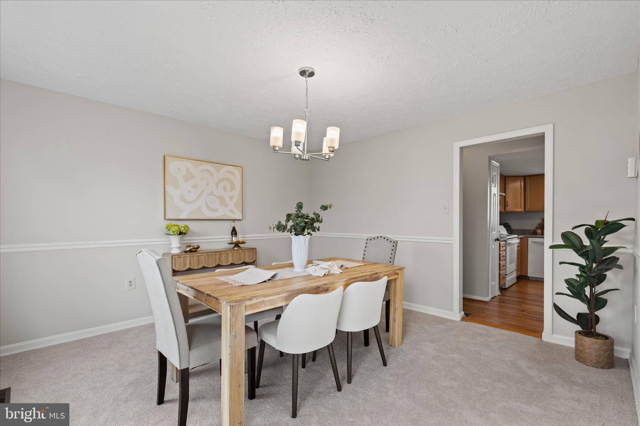 865 Moffett Forge Road Herndon, VA 20170 - Photo 11 of 62 a dining room with furniture potted plants and wooden floor