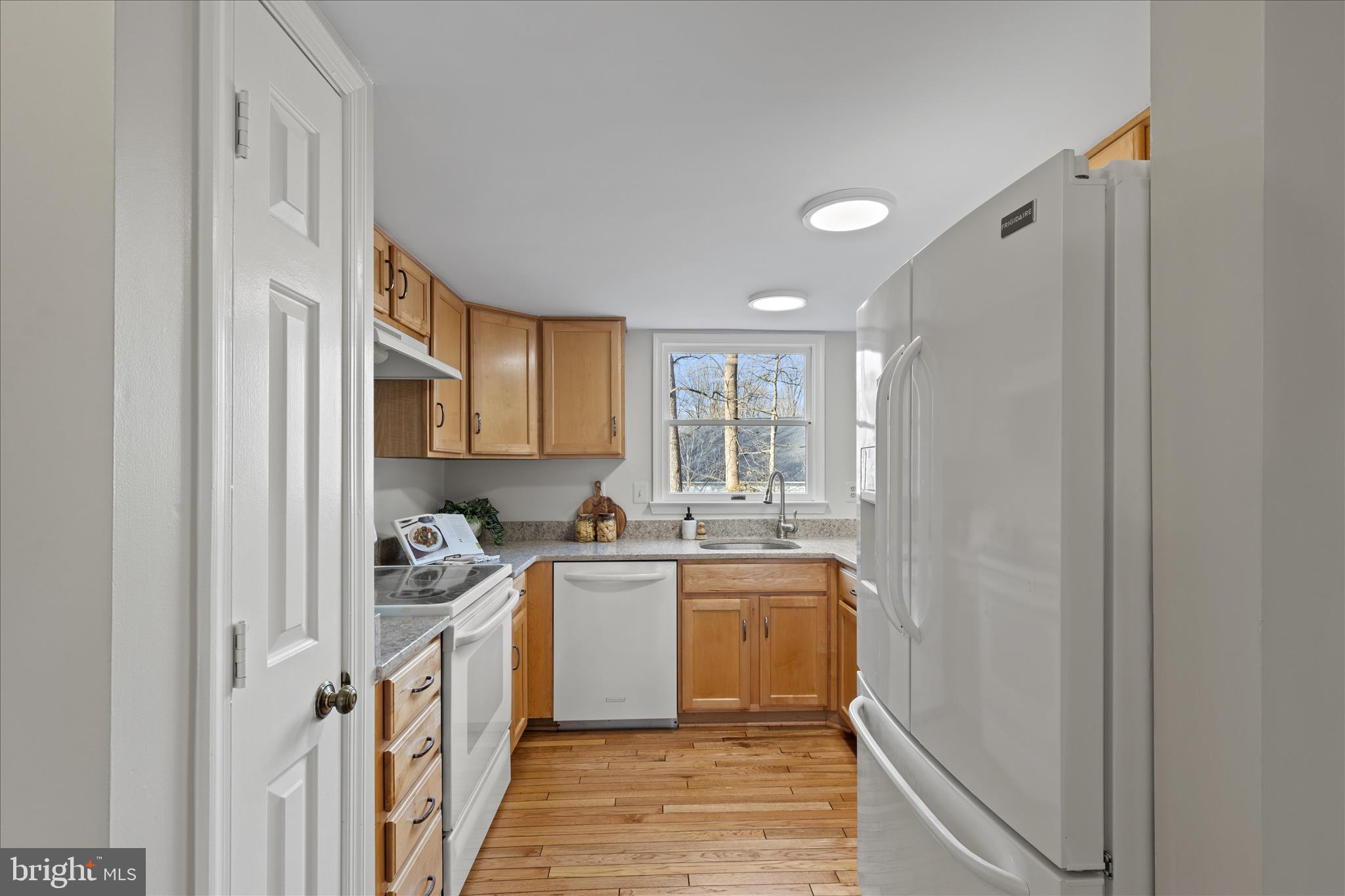 865 Moffett Forge Road Herndon, VA 20170 - Photo 15 of 62 a kitchen with a sink a stove cabinets and a refrigerator