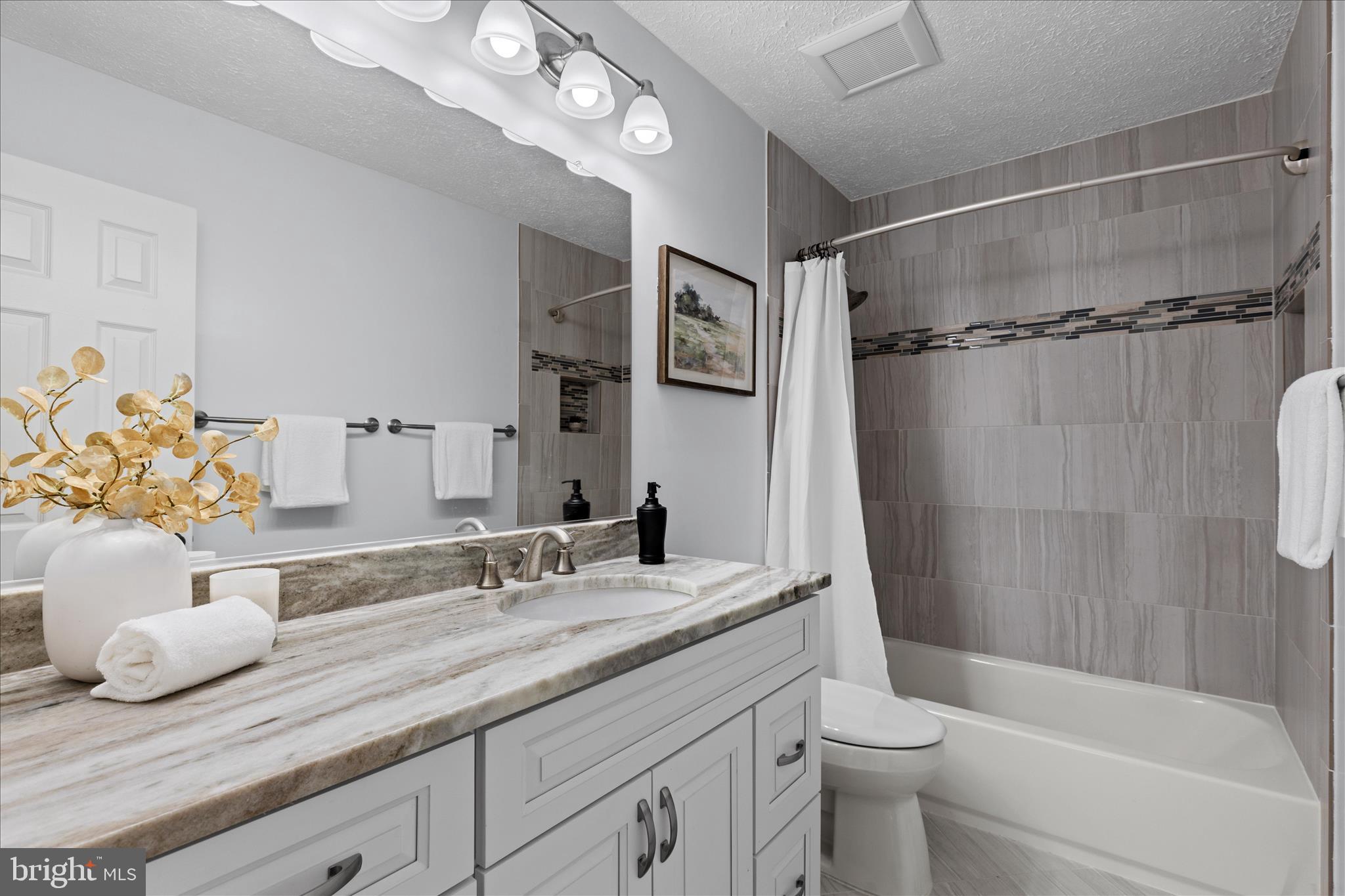 865 Moffett Forge Road Herndon, VA 20170 - Photo 34 of 62 a bathroom with a granite countertop sink a toilet and shower