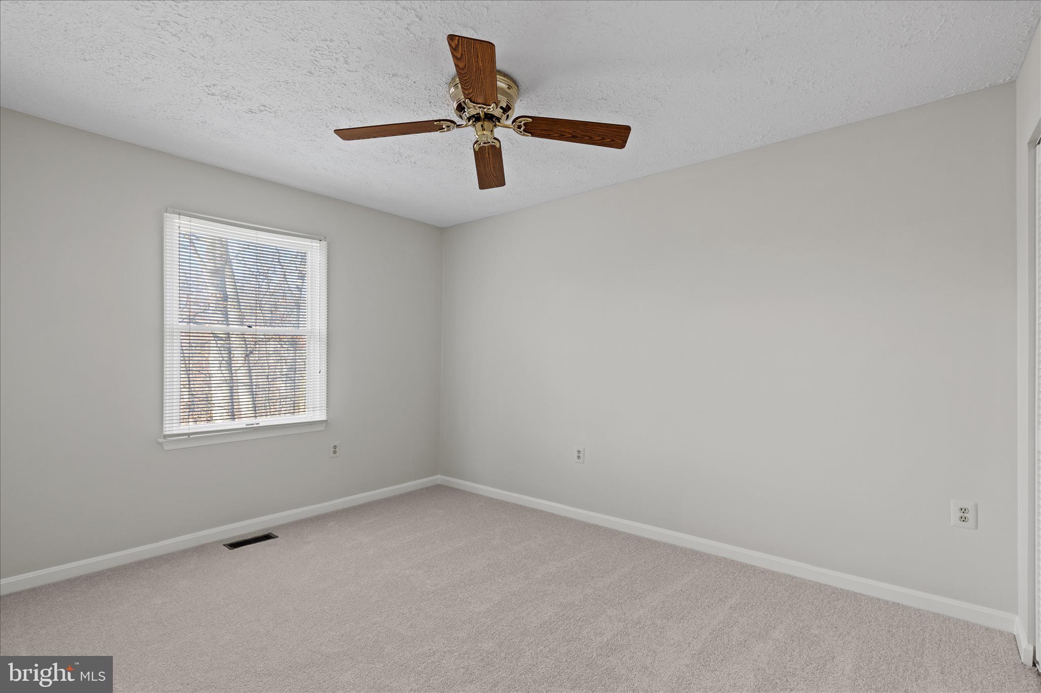 865 Moffett Forge Road Herndon, VA 20170 - Photo 37 of 62 an empty room with a window and a ceiling fan
